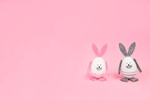 Easter. Easter bunnies, with their own hands on a pink background. mocap Stock Photos