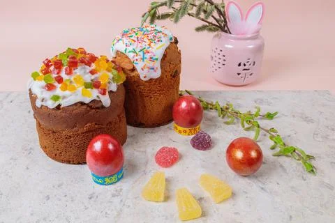 Easter. Easter cakes with eggs and bunny ears on a pink background. Easter. Stock Photos