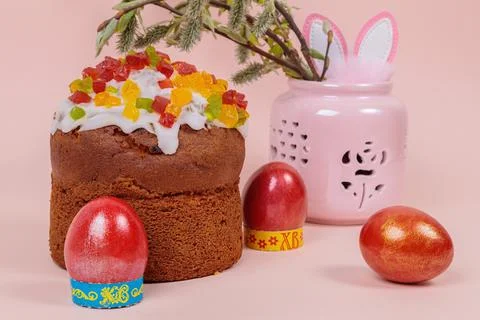 Easter. Easter cakes with eggs and bunny ears on a pink background. Easter. Stock Photos