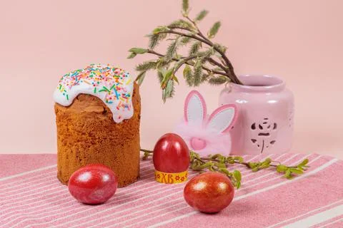 Easter. Easter cakes with eggs and bunny ears on a pink background. Easter. Stock Photos
