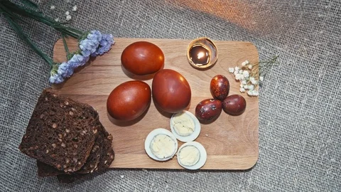 Easter, Easter egg, candle, bread and flowers Video stock 73438884