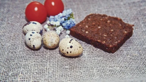 Easter, Easter eggs, bread and tomatoes Stock Footage 73418629