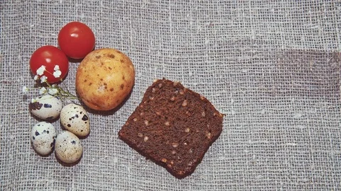 Easter, Easter eggs, bread and tomatoes Video stock 73419391