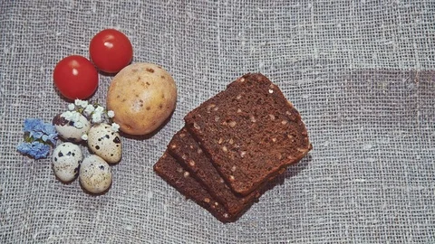 Easter, Easter eggs, bread, potatoes and tomatoes Stock Footage 73427211