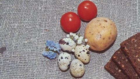 Easter, Easter eggs, bread, potatoes and tomatoes Stock Footage 73427849