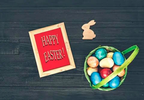 Easter, Easter eggs, multicolored eggs, basket, black background Stockfoto's