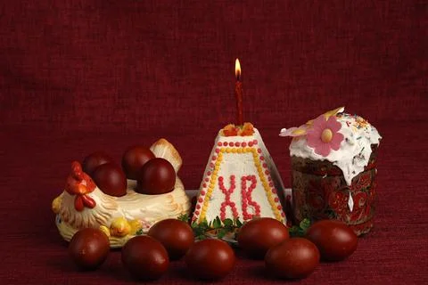 Easter. Easter holiday. Easter cake with a burning candle and painted eggs. Stock Photos