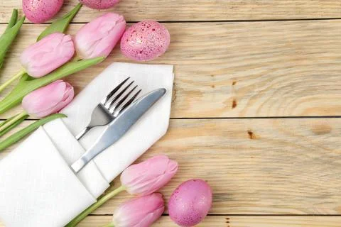 Easter. Easter table setting. Pink Easter eggs and flowers tulips on a natura Stock Photos
