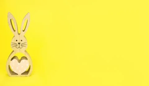 Easter . Easter, wooden bunny on a yellow background.Banner copy space. Stock Photos