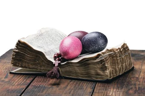 Easter egg and a rosary on an open bible Stock Photos