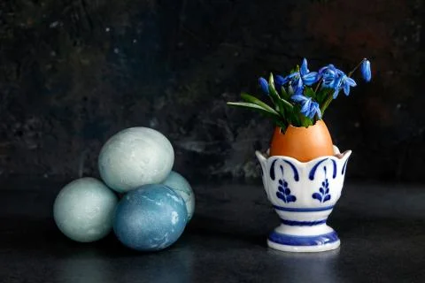 Easter egg and snowdrops in an egg stand Stock Photos