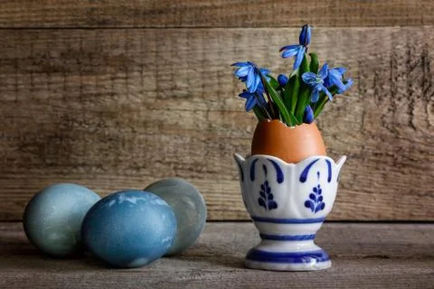 Easter egg and snowdrops in an egg stand Stock Photos