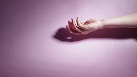Easter egg and woman's hand on a pink background, hand reaching for a decor.. Stock Footage 262946639