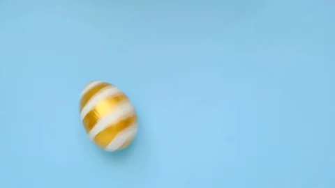 Easter egg are spinning turning on blue table. Egg trendy colored classic blue Stock Footage 126313108