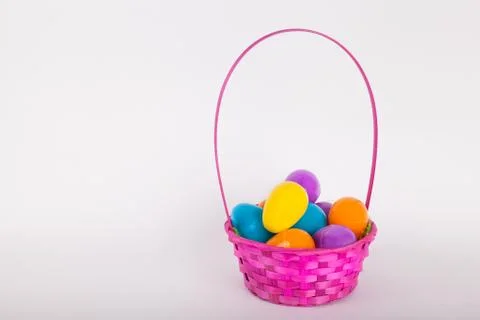 Easter egg basket filled with plastic colored easter eggs Stock Photos