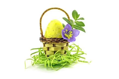 Easter egg in a basket isolated on white background Stock Photos
