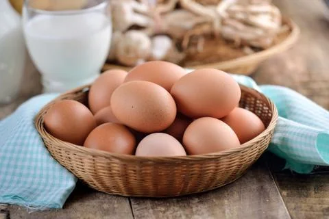 Easter egg in a basket on wodden table Stock Photos