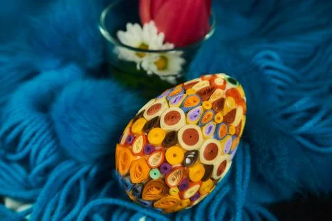 Easter egg on a blue-blue wool scarf Stock Photos