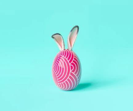 Easter egg with bunny ears against blue background Stock Photos