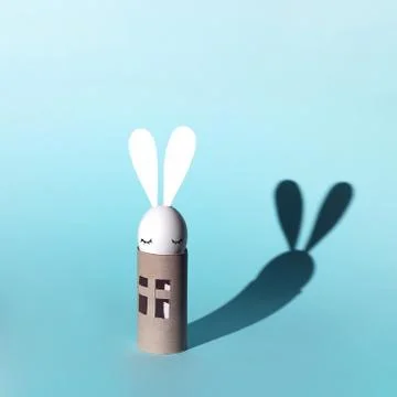 Easter egg bunny on self-insulation. In the toilet paper cabin. A concept on Stock Photos