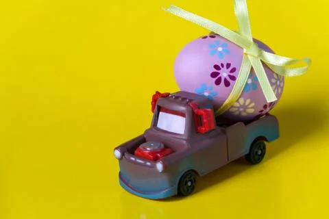 Easter egg on the car a yellow background Stock Photos