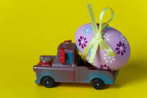 Easter egg on the car a yellow background Stock Photos