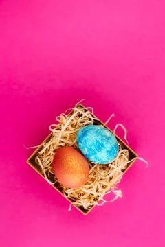 Easter egg is colored blue with gold and orange with gold. Stock Photos