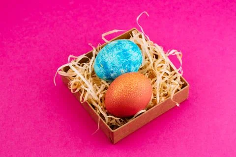 Easter egg is colored blue with gold and orange with gold. Stock Photos