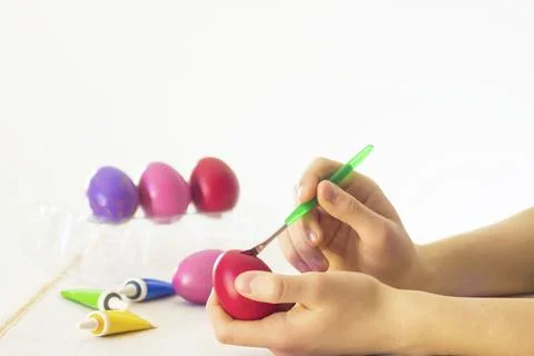 Easter egg coloring process with a brush of acrylic paints Stock Photos