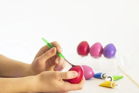 Easter egg coloring process with a brush of acrylic paints Stock Photos