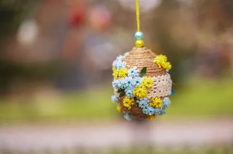 Easter egg decorated with small colorful flower patterns on a tree Stock Photos