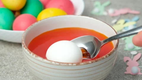 Easter egg dyeing process, egg placed in dye, slow motion Stock Footage 300089782