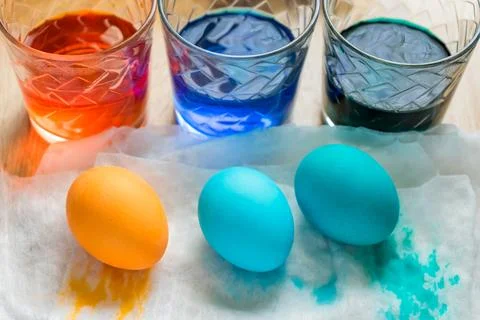 Easter Egg Dying Process. Transparent glass cups with colored water and Col.. Stock Photos