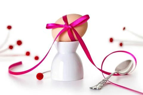 Easter Egg Easter egg with pink ribbon on white background. Composition wi... Stock Photos