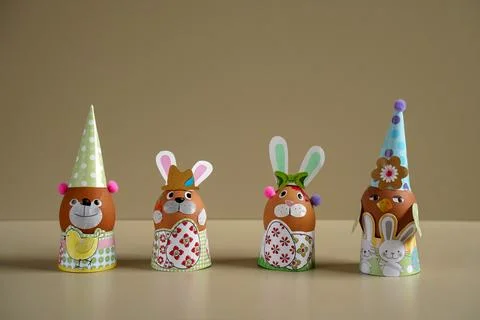 Easter egg figurines DIY. Easter rabbit figurine with colorful eggs. Easter e Stock Photos
