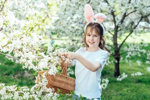 Easter Egg Hunt with Child in Flowering Orchard Stock Photos
