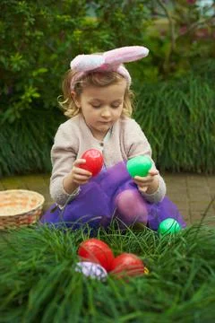 Easter Egg Hunt with Toddler in Spring Outfit Stock Photos