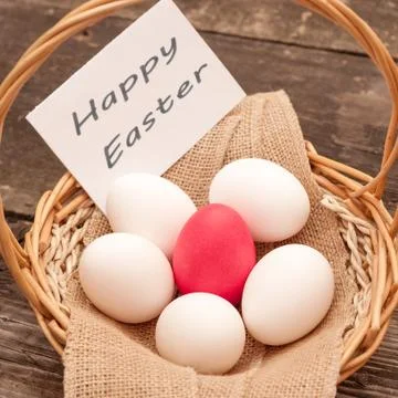 Easter Egg lying in a basket Stock Photos