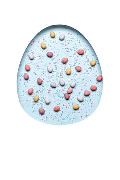 Easter egg made from hole with scattering of chocolate eggs in sugar glaze and Stock Photos