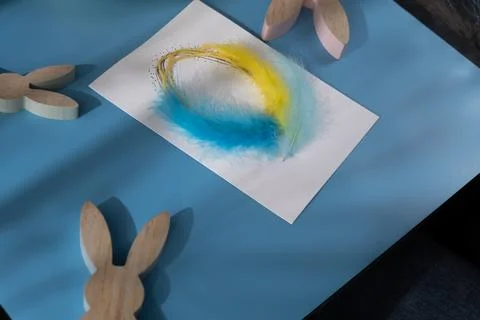 EASTER egg made of rope and feathers Sustainable preparation Diy process of Stock Photos