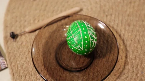 Easter egg with national decor lies on a plate. Easter egg painting. Stock Footage 170125819