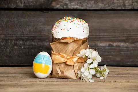 Easter egg with a painted flag of Ukraine, Easter cake and a blossoming branc Stock Photos