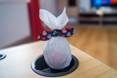 Easter egg in paper in the shape of a bunny with a bow. Symbol of Easter Stock Photos