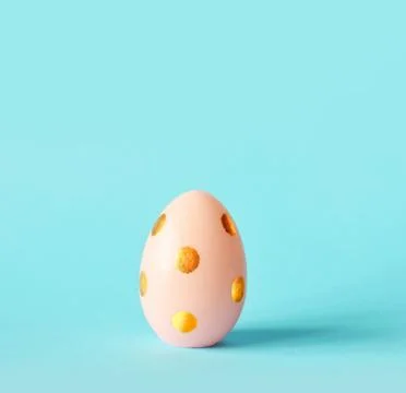 Easter egg on pastel blue background. Happy Easter concept. Minimal concept. Stock Photos