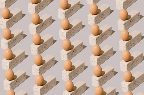 Easter egg pattern made of natural eggs on top of travertine marble blocks. Stockfoto's
