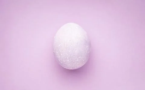 Easter egg on a purple background. Top view. Stock Photos