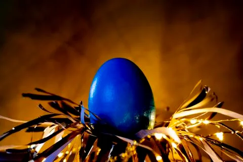 Easter egg rabbit concept on a nest. Stock Photos