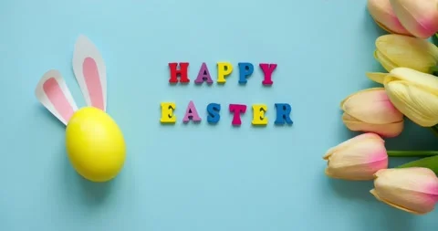 Easter egg with rabbit ears, tulips and the inscription Happy Easter Stock Footage 235771805
