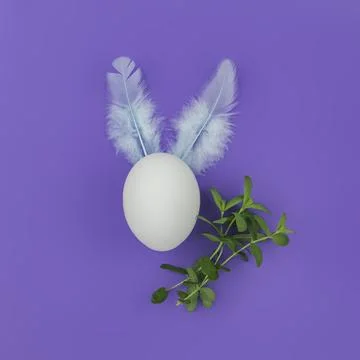 Easter egg with rabbit ears on a violet background and green grass. Minimalis Stock Photos