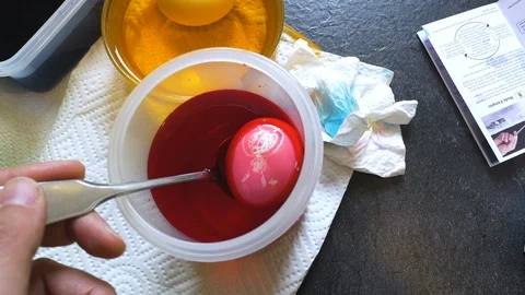Easter Egg in Red Dye Bowl Stock Footage 99694746